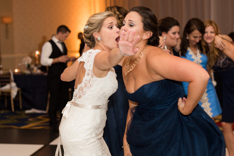 bride and maid of honor dancing at reception