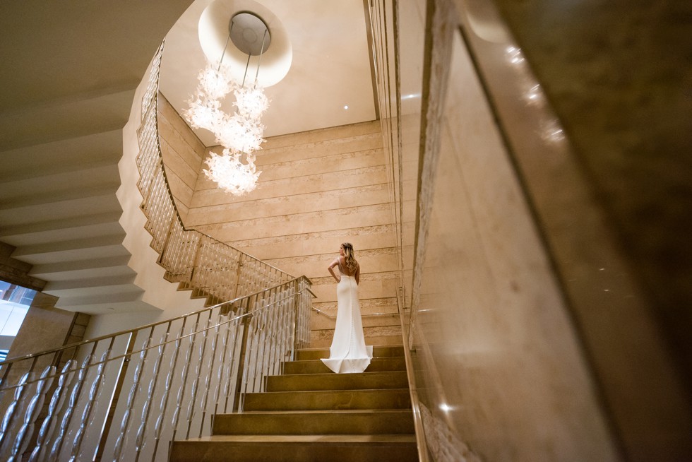 Four Seasons Hotel baltimore bride wearing a martina liana wedding dress on the grand gold staircase