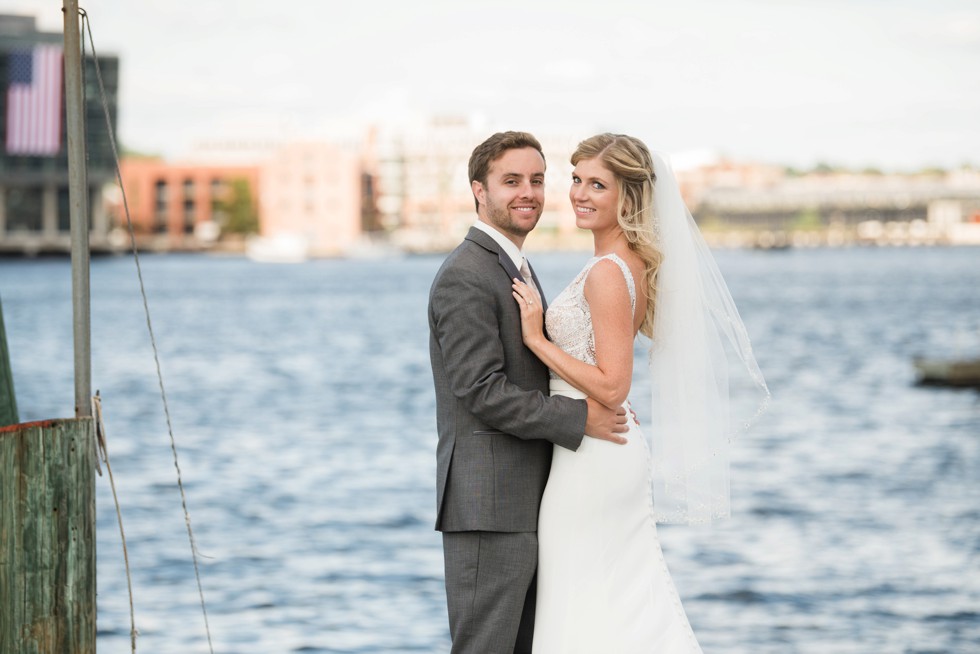 Baltimore Museum of Industry wedding photos with a sailboat on the baltimore harbor