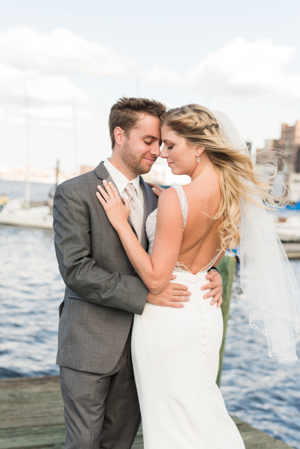 Baltimore Museum of Industry wedding photos with a sailboat on the baltimore harbor