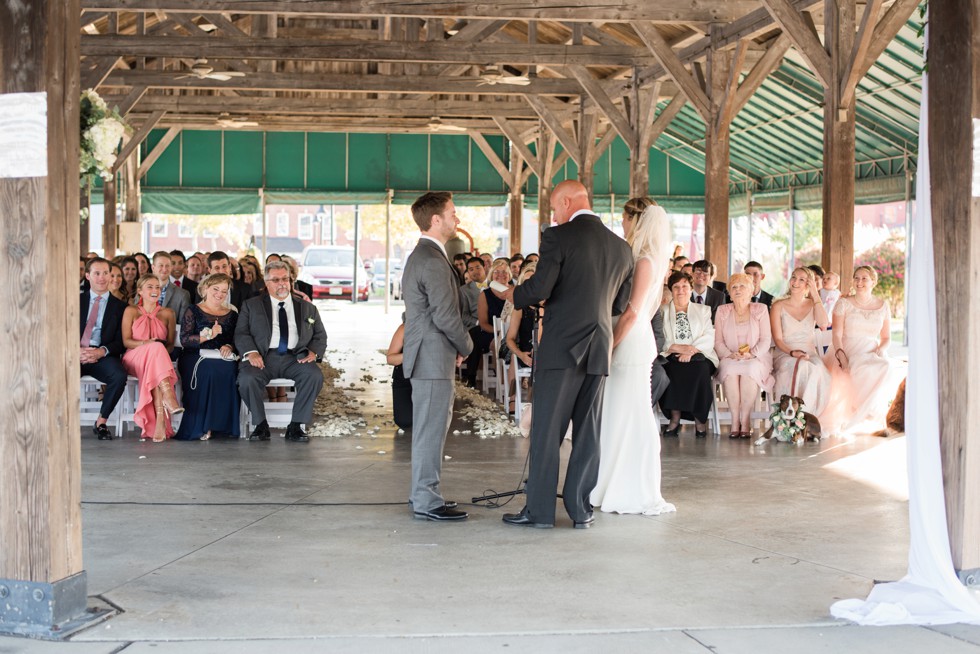 Wedding ceremony overlooking the Baltimore Harbor under the wooden barn at BMI