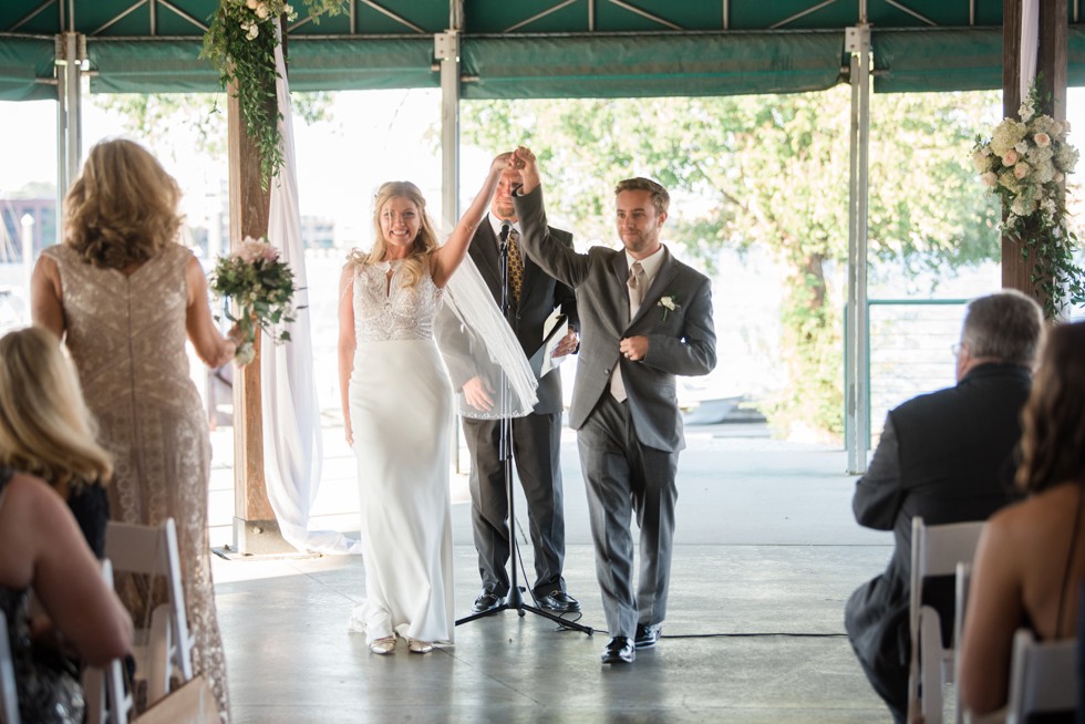 Wedding ceremony overlooking the Baltimore Harbor under the wooden barn at BMI