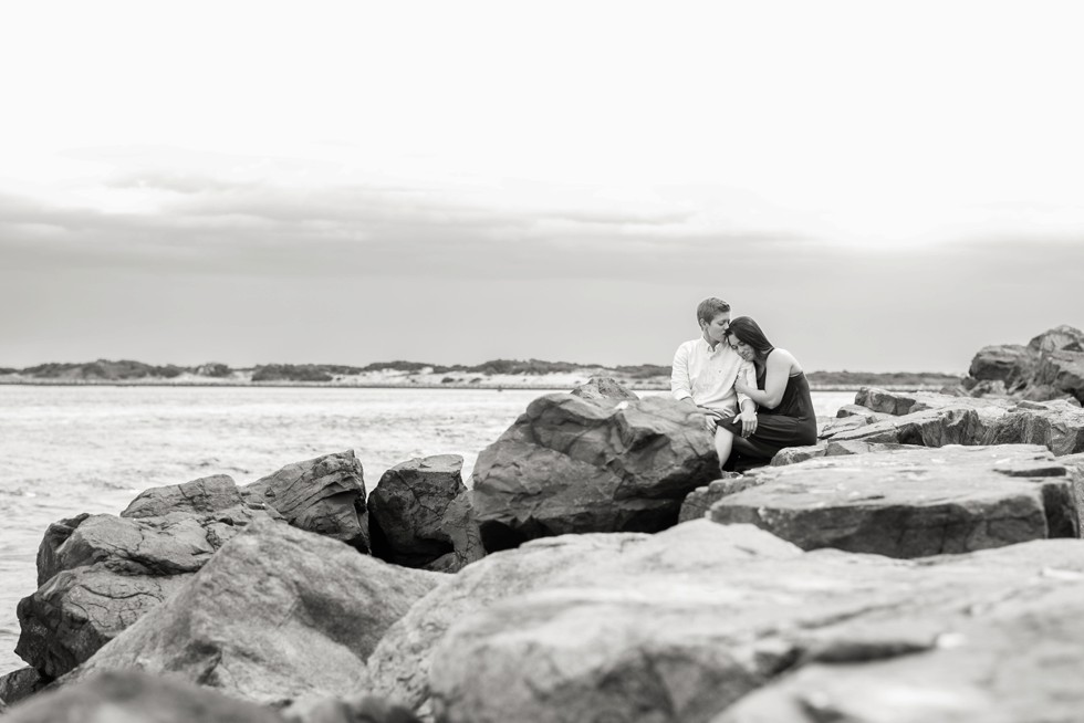 Couple in love on the rocks of the jersey shore beach at Barnegat light