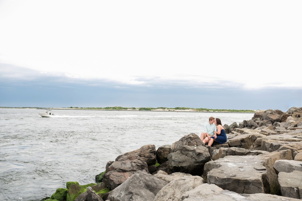 female engagement photos on the rocks at Barnegat Lighthouse