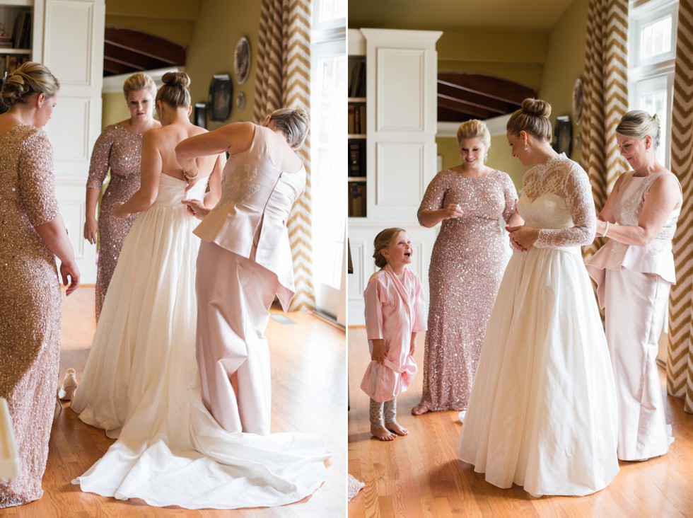 Bride getting into her WTOO by Watters strapless bridal gown with lace coverlet