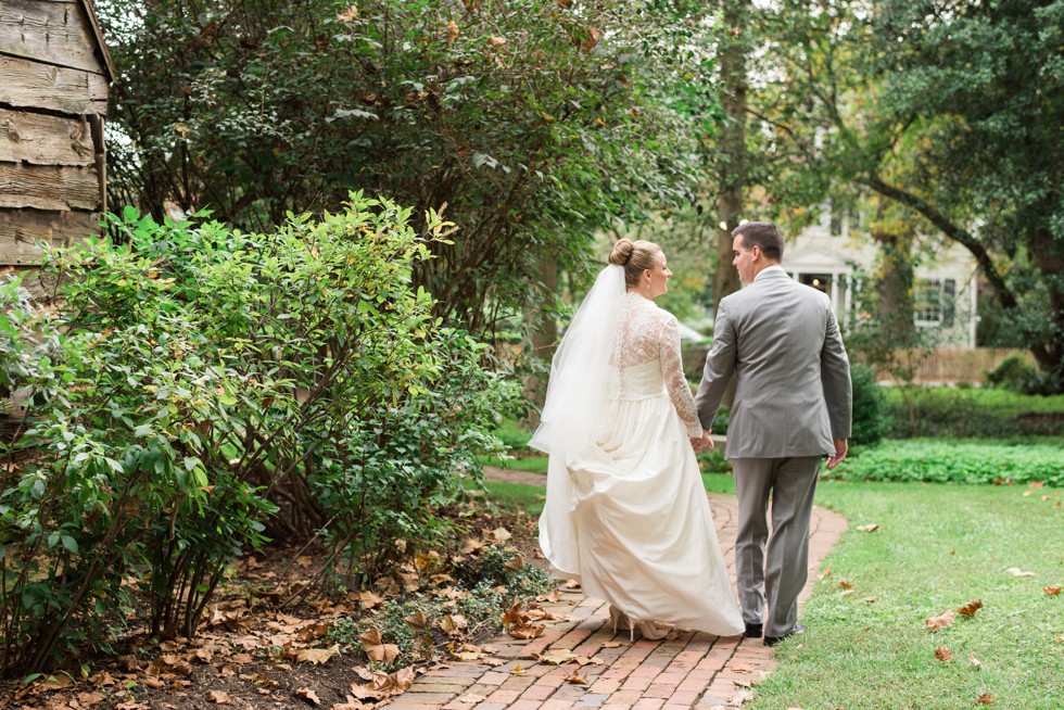 bride and groom walking through Elkridge Furnace Inns wedding venue