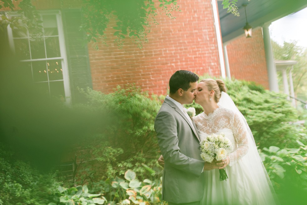 Newlywed Couple Portraits through green leaves at Elkridge Furnace Inn