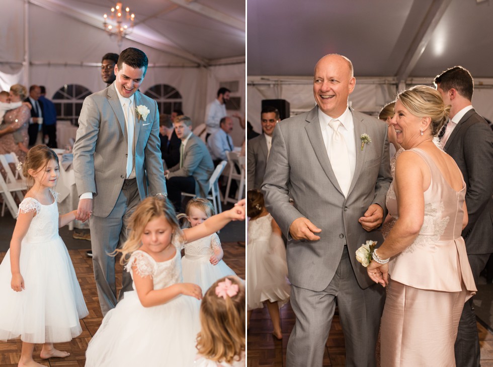 grey suits and kids dancing at a tented reception