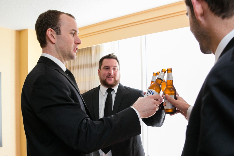 Groom getting in his Jos A Bank black Tux