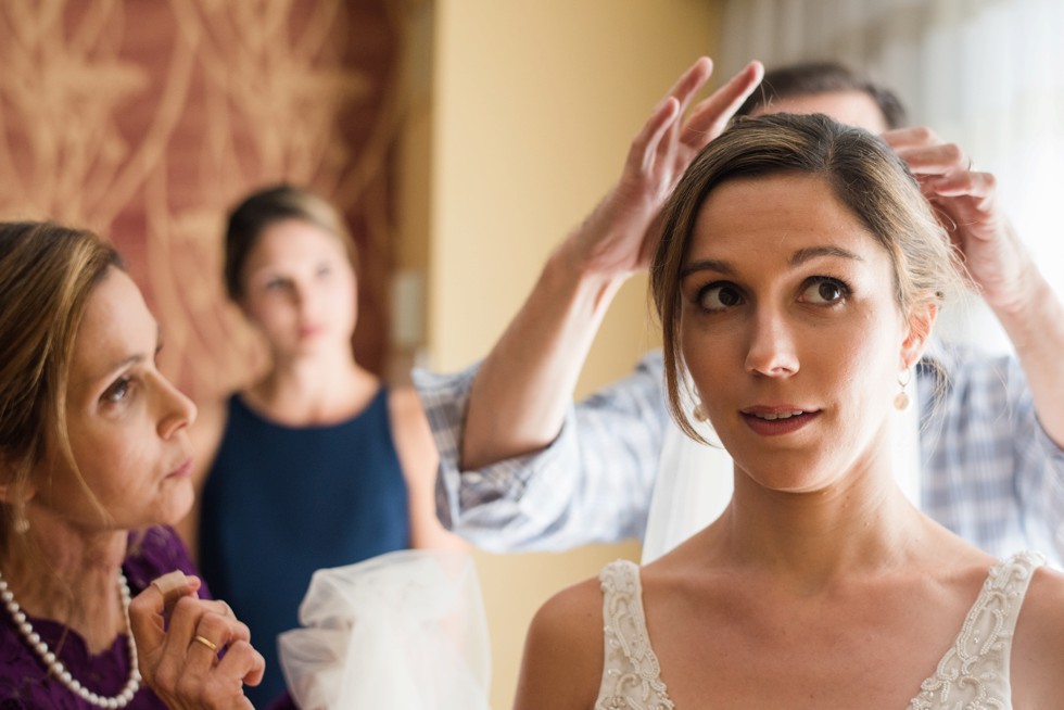 Putting the bridal veil on in her Love Couture Bridal dress with moms and sisters