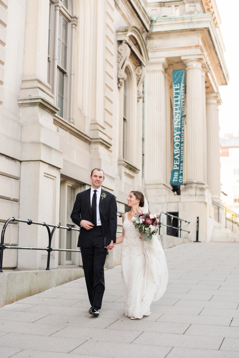 Peabody Library wedding photos of bride and groom walking down Mount Vernon hills