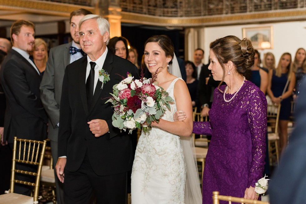 Parents walking the bride down the aisle at peabody library ceremony