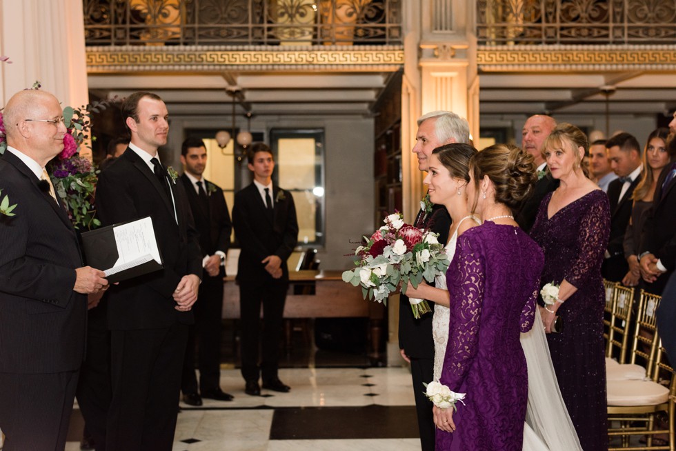 Parents walking the bride down the aisle at peabody library ceremony