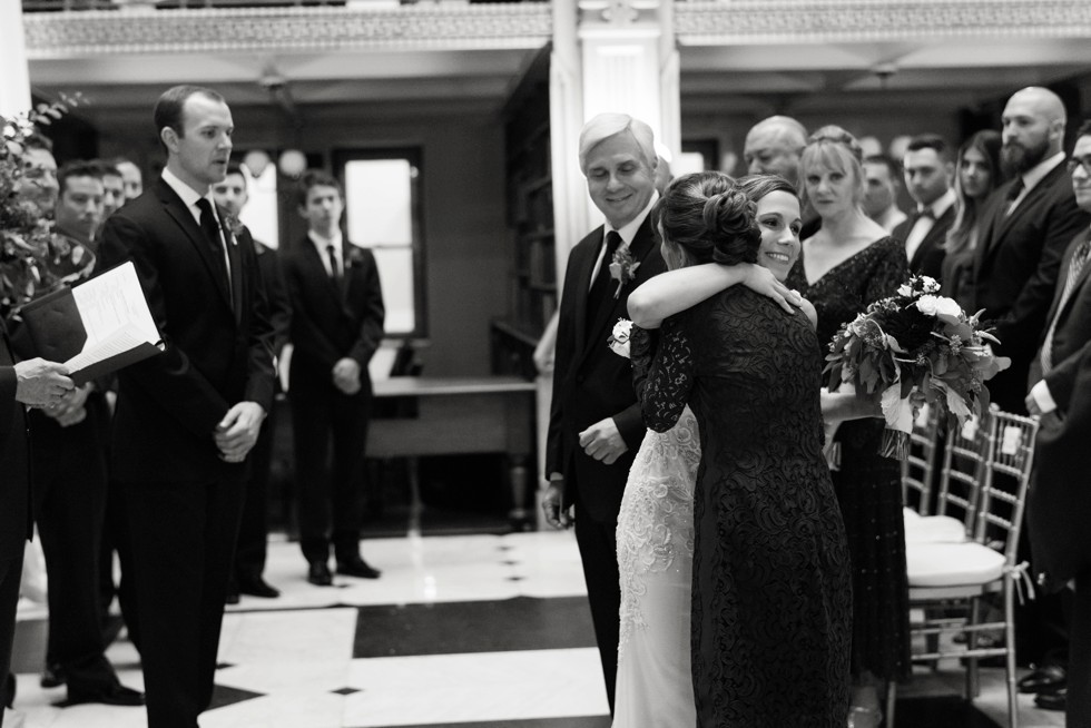 Parents walking the bride down the aisle at peabody library ceremony