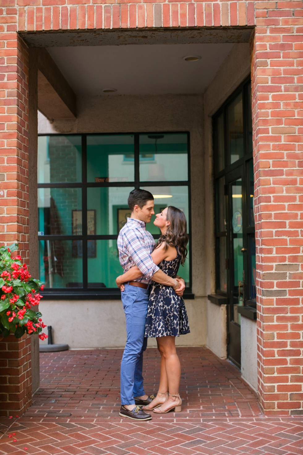 Brick building with plaid mens shirt and navy lace dress engagement outfits