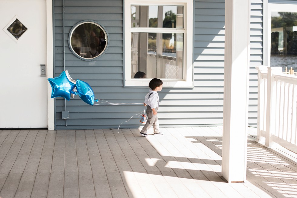 Ring bearer walking on the waterfront to his Ceremony at Anchor Inn