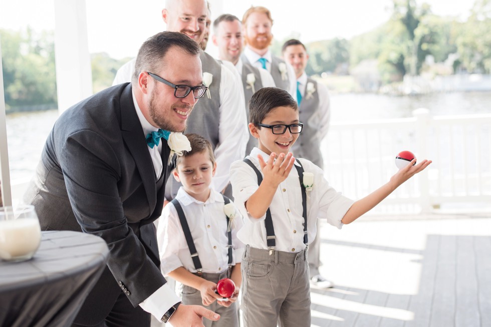 Groom in teal bowtie walking on the waterfront to his Ceremony at Anchor Inn