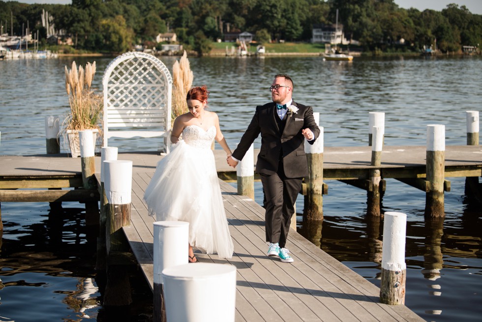 Bride and groom skipping on the docks at Anchor Inn