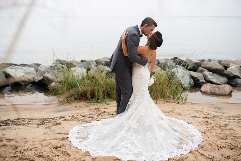 Groom dipping the bride on the beach