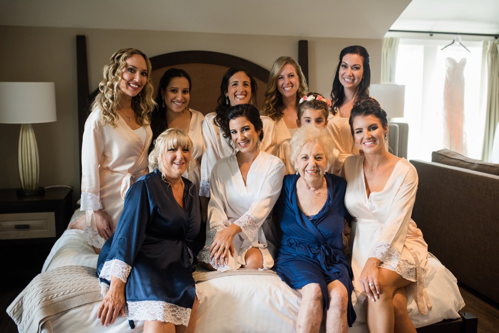 Bridesmaids and Bride with family in matching blush robes