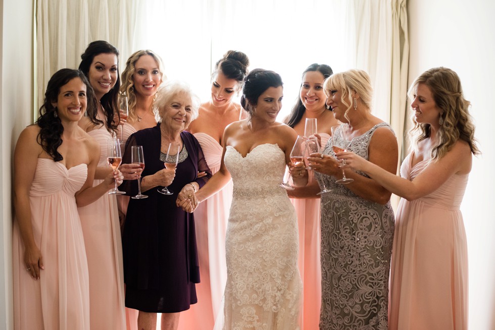 Bride and her friends and mom having a champagne rose toast