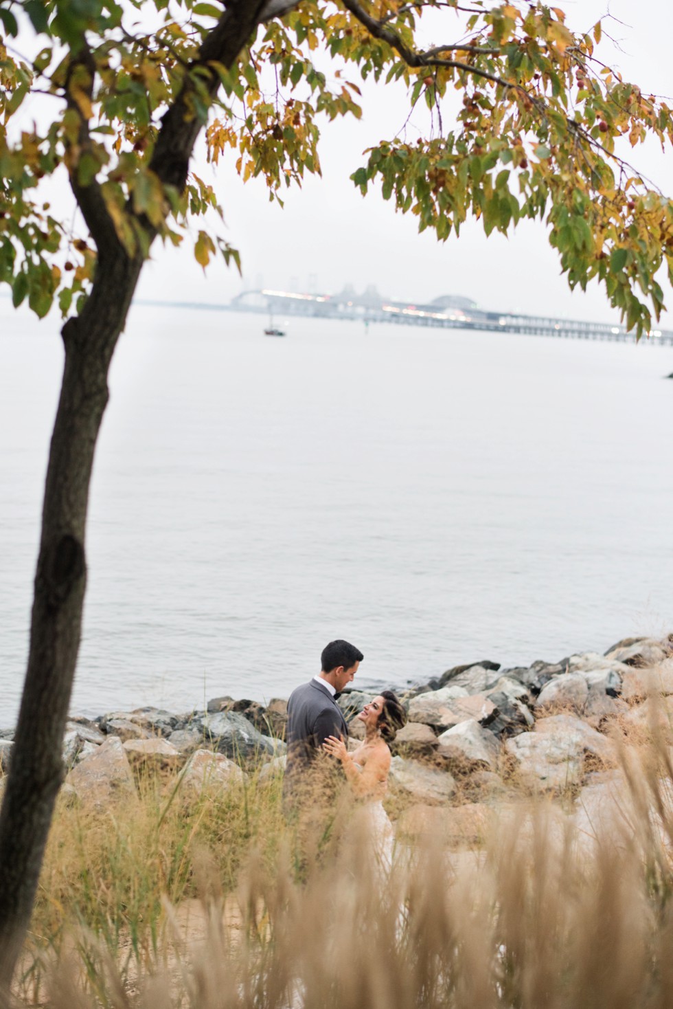 Chesapeake Bay bridge in the background of fall wedding portraits on the Beach