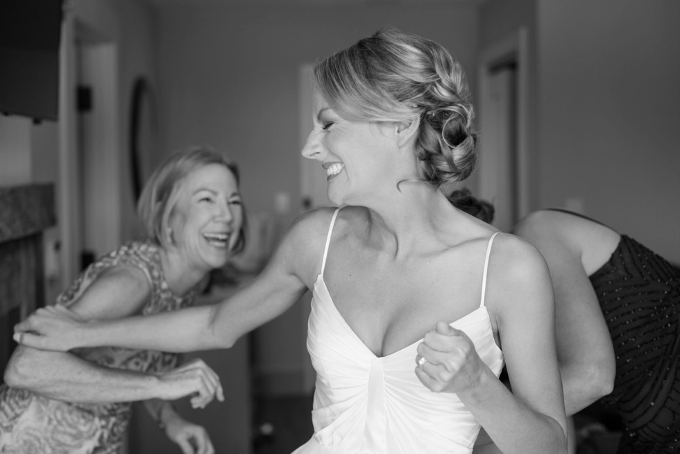 Bride and her mom getting in her wedding dress at The Inn at the Chesapeake Bay Beach Club