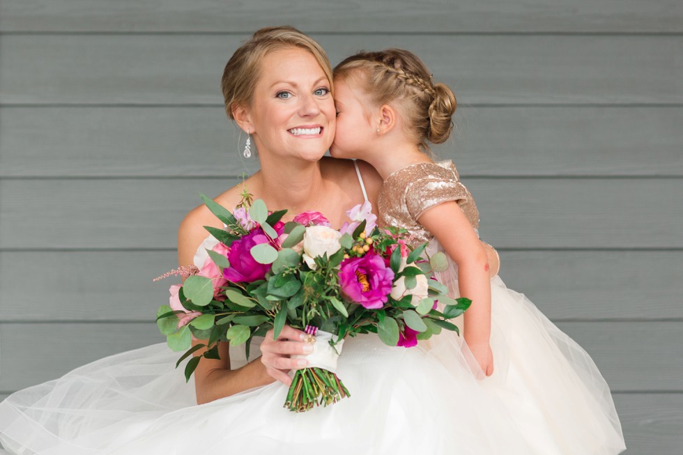 Bride and flower girl with bright pink flowers from Floral and Bloom Designs