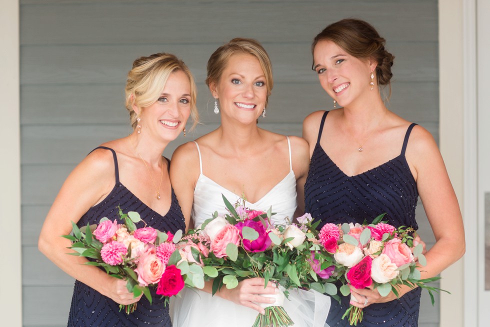 Bride and bridesmaids with bright pink flowers from Floral and Bloom Designs