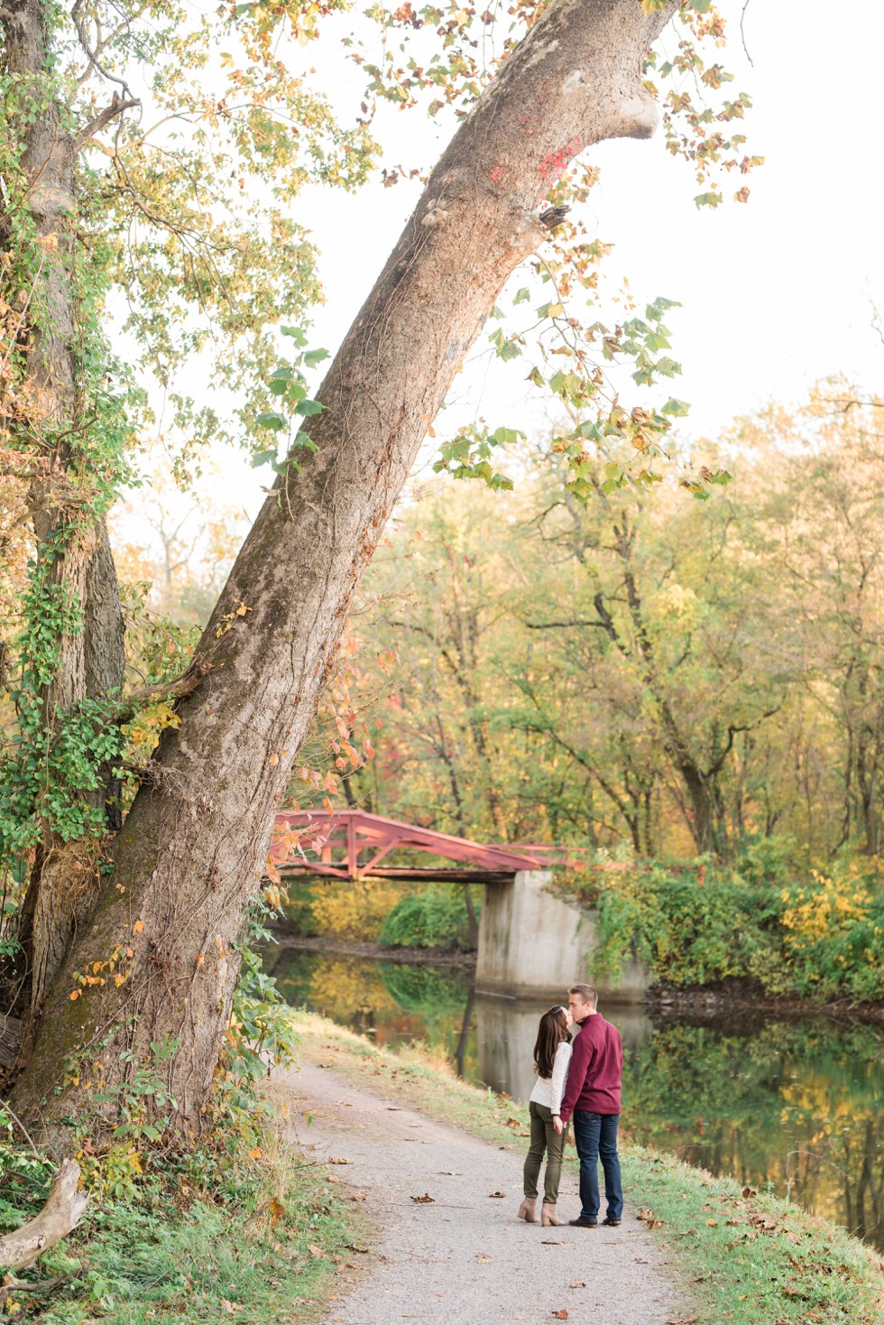 Fall engagement photos in Washington Crossing Historic Park red bridge