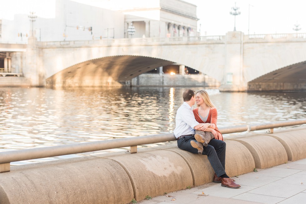 engaged couple sitting on the schuylkill river