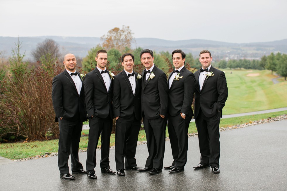 groomsmen in black tuxes on a mountain wedding