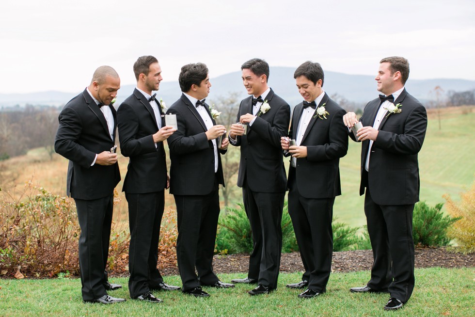 groomsmen in black tuxes on a mountain