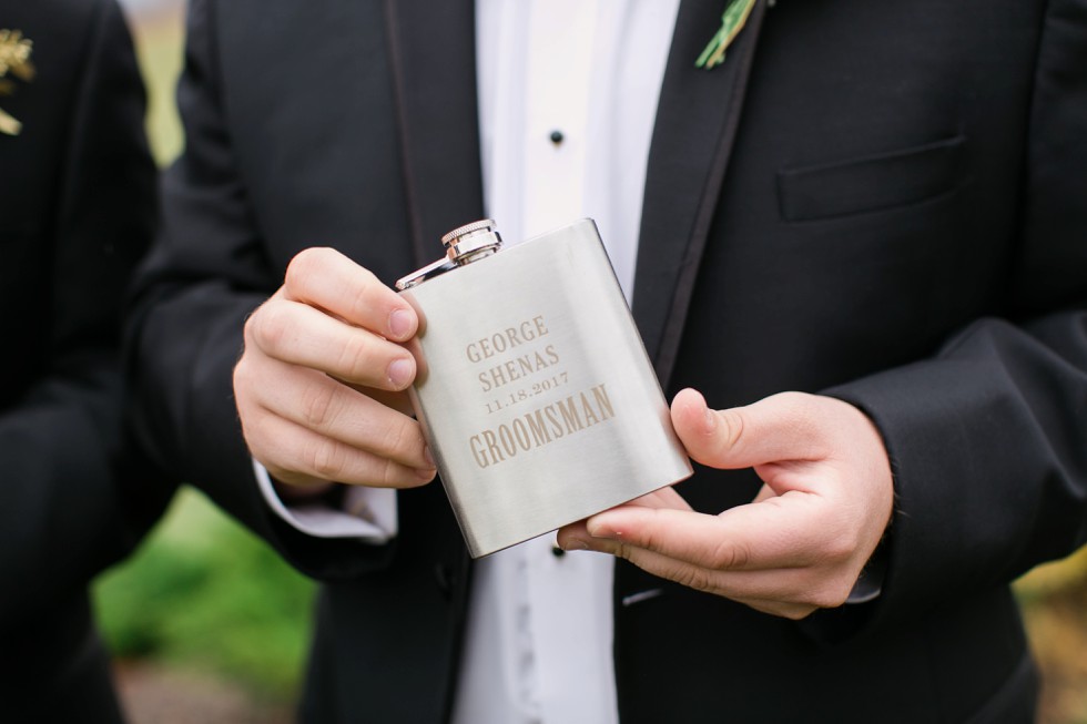 groomsmen in black tuxes on a mountain