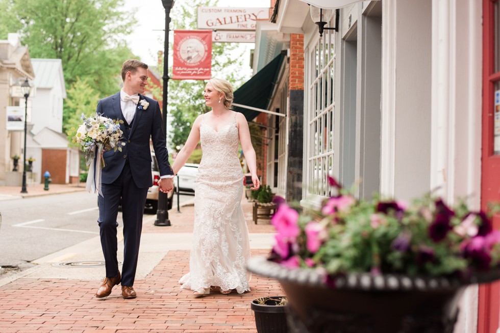 bride and groom strolling on the charming street of Easton