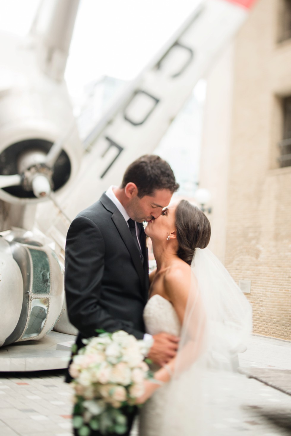 bride and groom first look at PAFA in front of plane