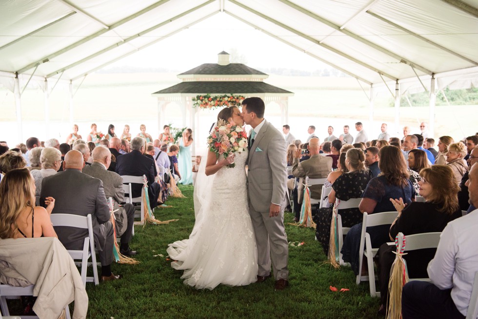 Friendly farm wedding ceremony under a tent