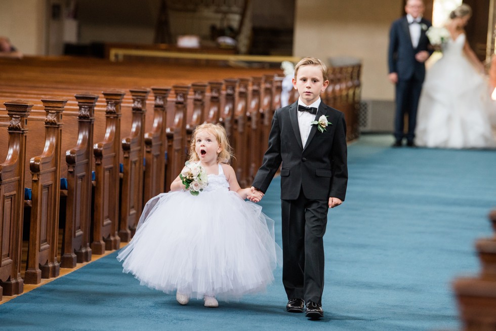 cute flower girl reaction to United States Naval Academy chapel wedding ceremony