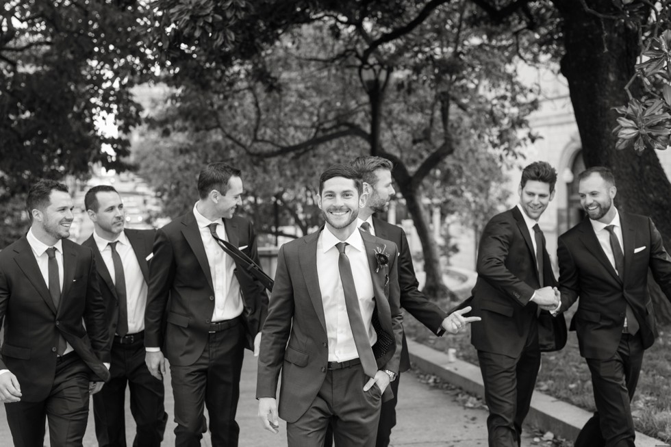 Groom and groomsmen Mount Vernon Place across from Walters Art Museum