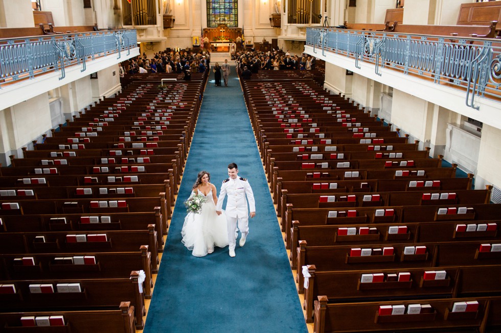 bride and groom walking down USNA Chapel aisle