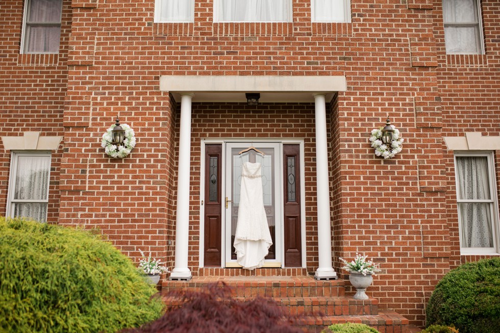 bridal dress on a brick house