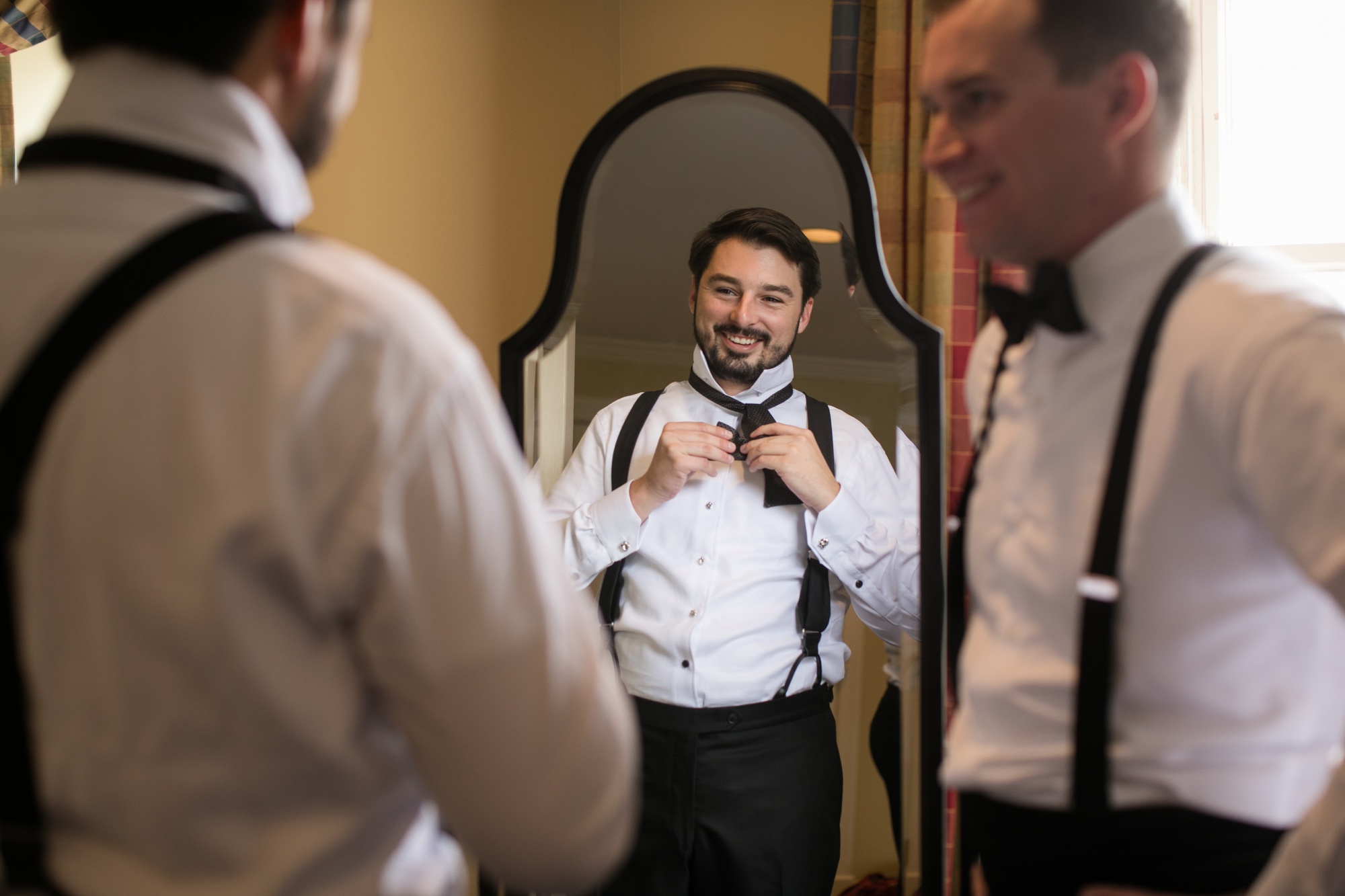 Groom getting ready bowtie