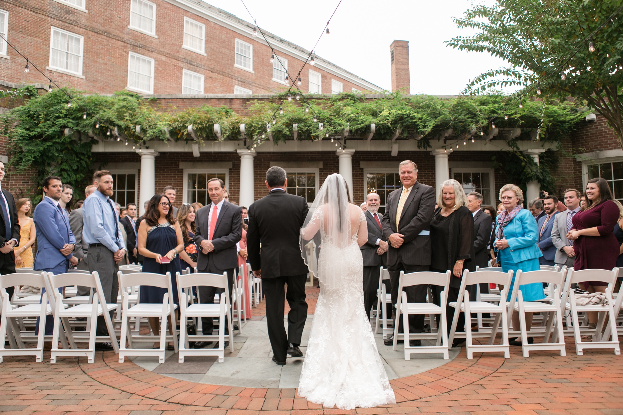 The Tidewater Inn Courtyard bride coming down the aisle