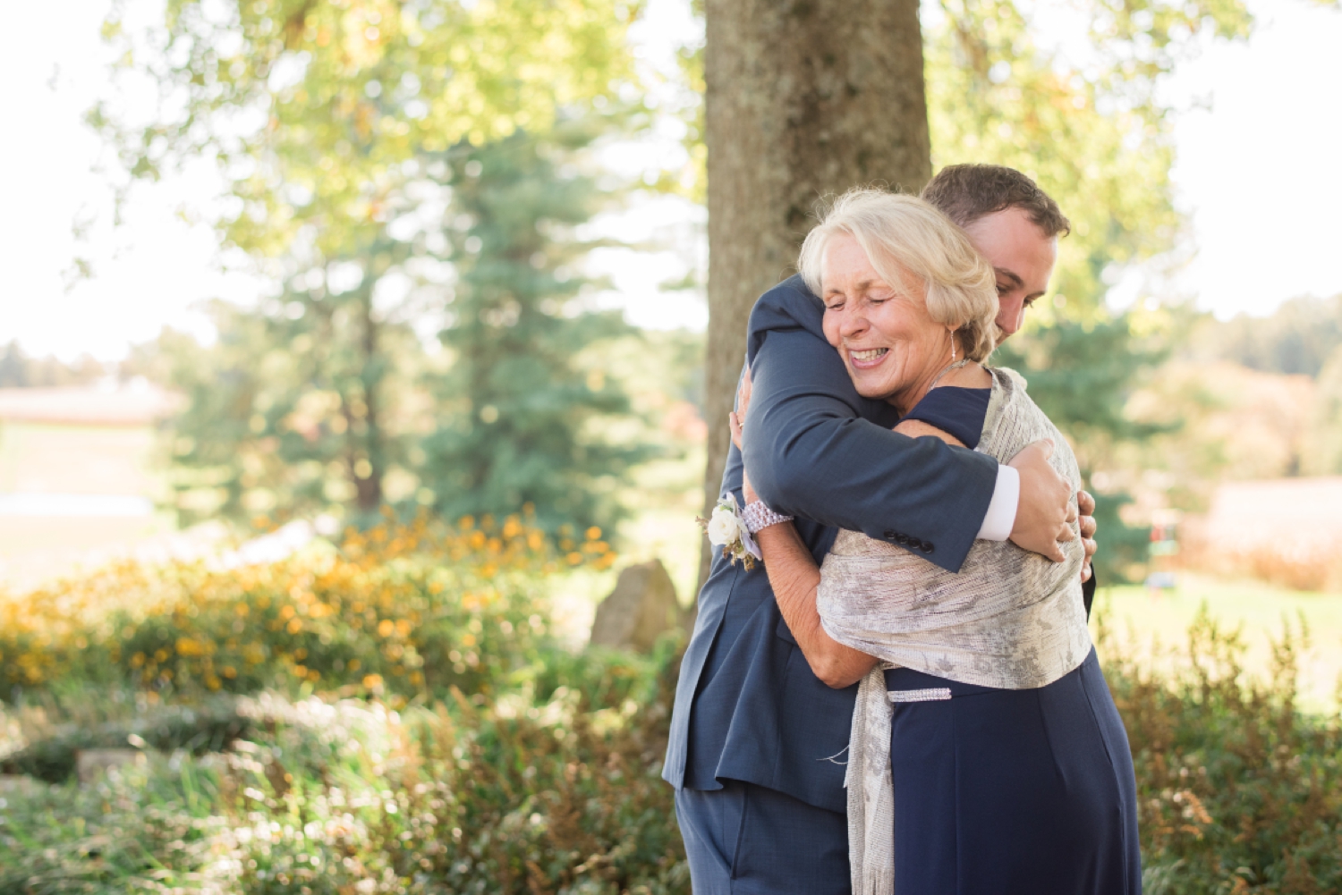 groom and his mom embracing for a hug