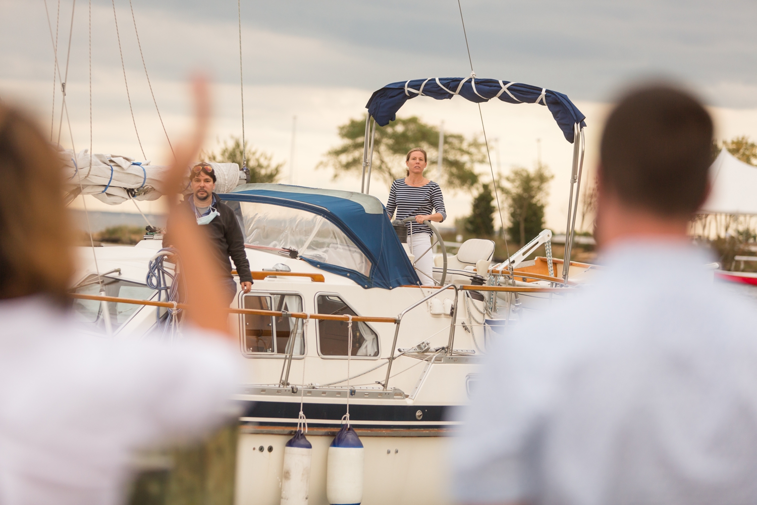 couple sailing into her elopement on the docks