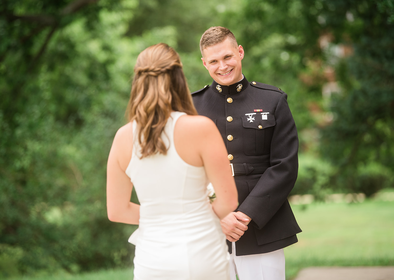 groom smiles at his bride 