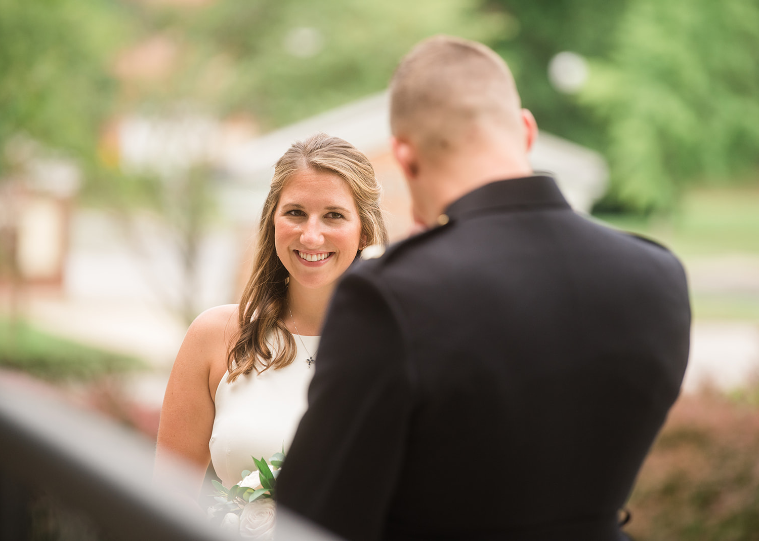 Bride smiles as she looks at the groom