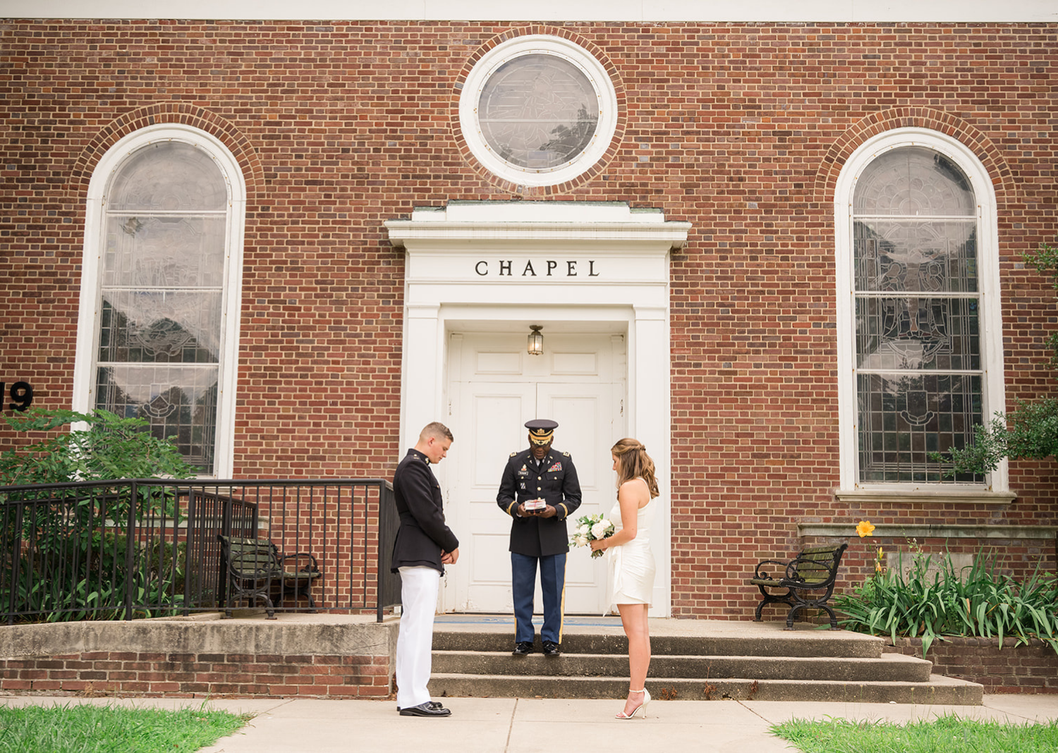 bride and groom vow their heads as the reverend makes a prayer