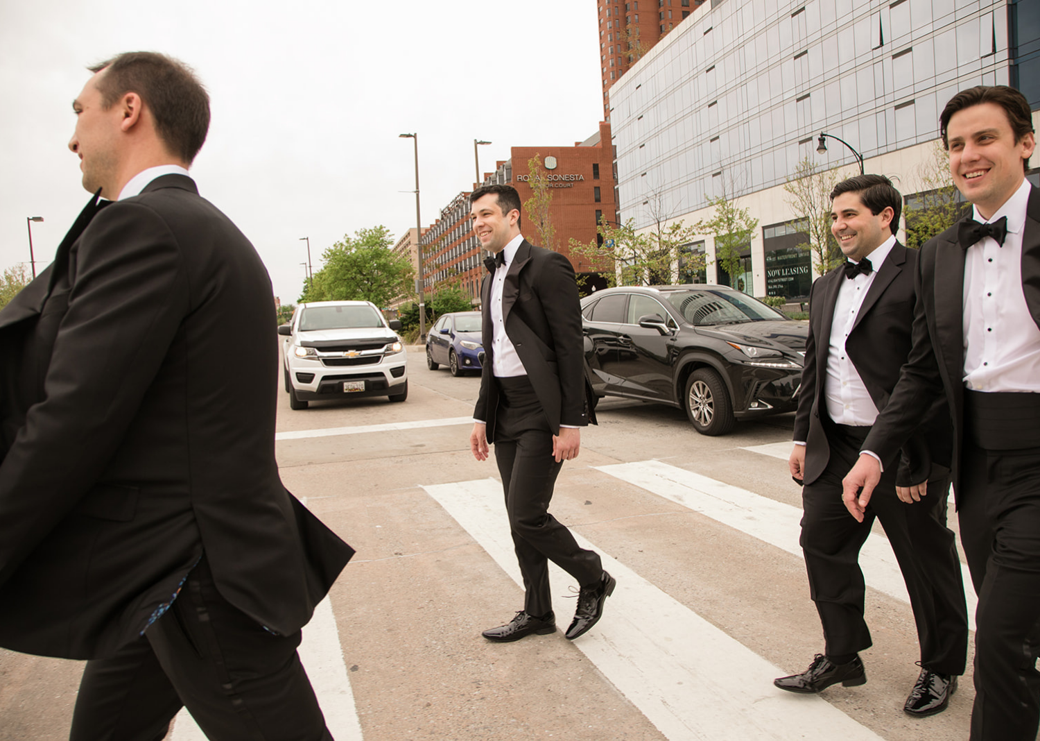 groomsmen crossing the street in front of the Belvedere Hotel