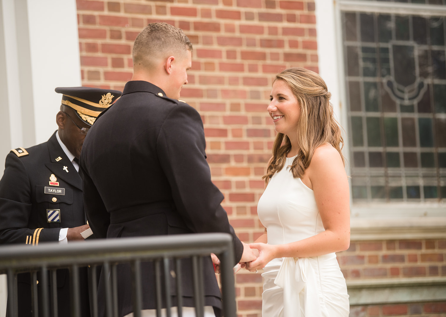 bride and groom smile as they look at each other 